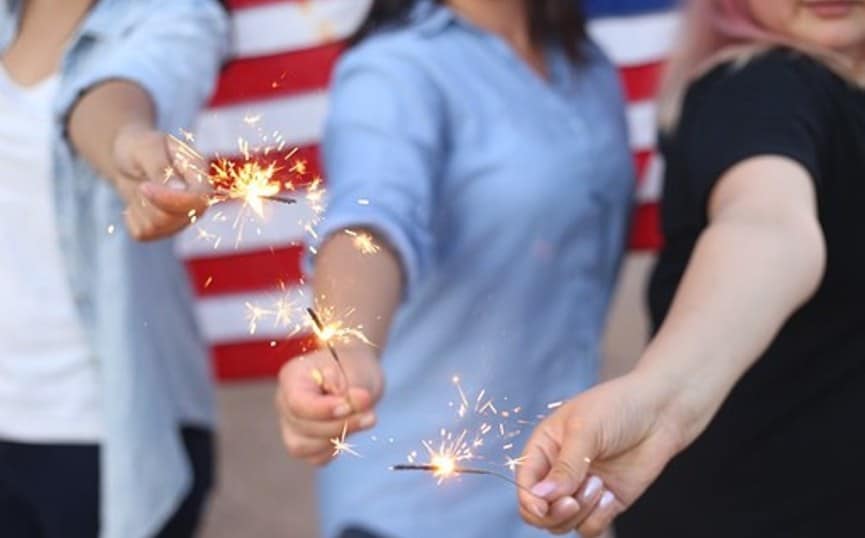 People holding Fourth of July sparklers