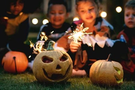 Kansas City halloween for kids - two kids in costume with sparklers and a jack-o-lantern