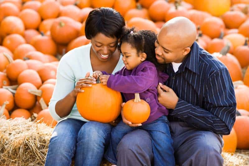 Kansas City family holding pumpkins