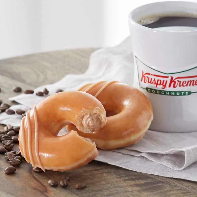 Krispy Kreme original glazed donuts and cup of coffee
