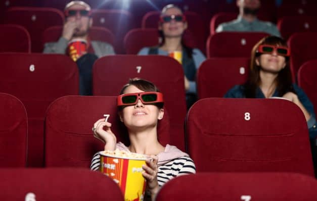 Kid watching movie in a theatre