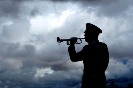 Bugle player playing Taps