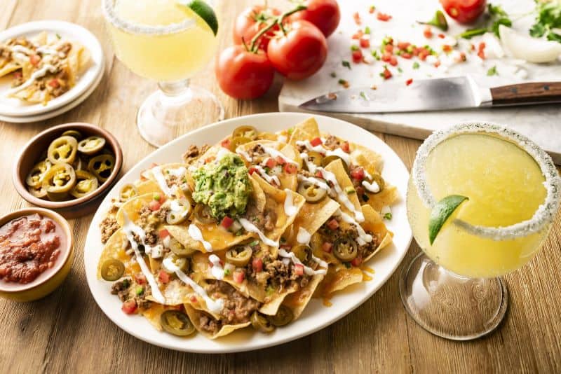 National Nacho Day Deals in Kansas City - plate of nachos with a margarita at On the Border