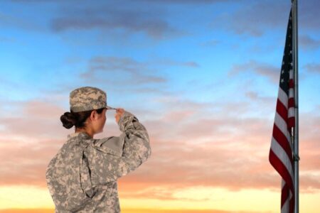 Kansas city Veterans Day Events and Deal - female solider saluting American flag