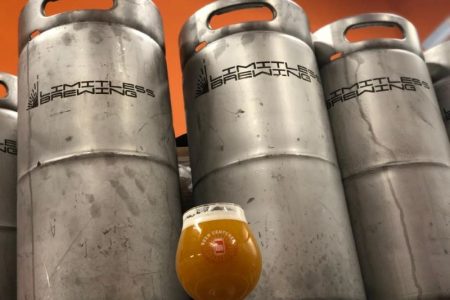 Limitless Brewing in Lenexa, KS - three kegs and a glass of beer