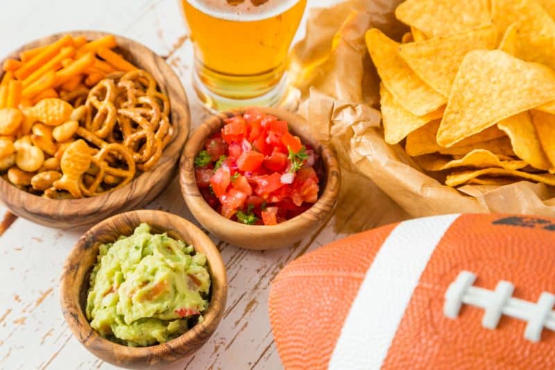 Kansas City Chiefs watch parties - various snacks, beer and a football on a table