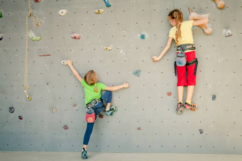 Rock climbing discounts - two girls climbing