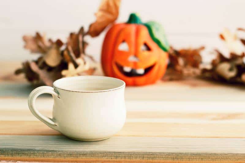 Cup of tea with pumpkin in background