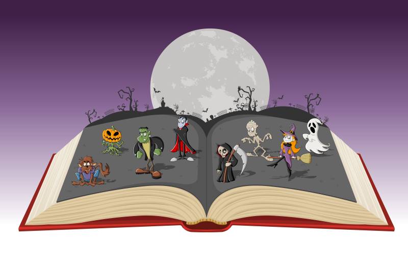 Open Halloween book with cute monsters