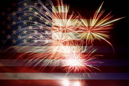 American flag with Fourth of July firewworks