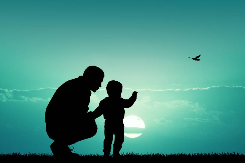 Father with child at sunset